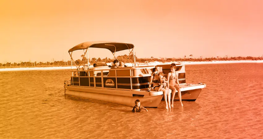 Boats on the Mallacoota inlet with calm water and bushland